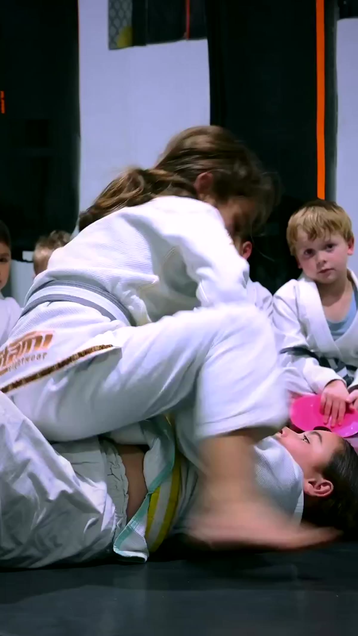 Kids BJJ rolling on the mats