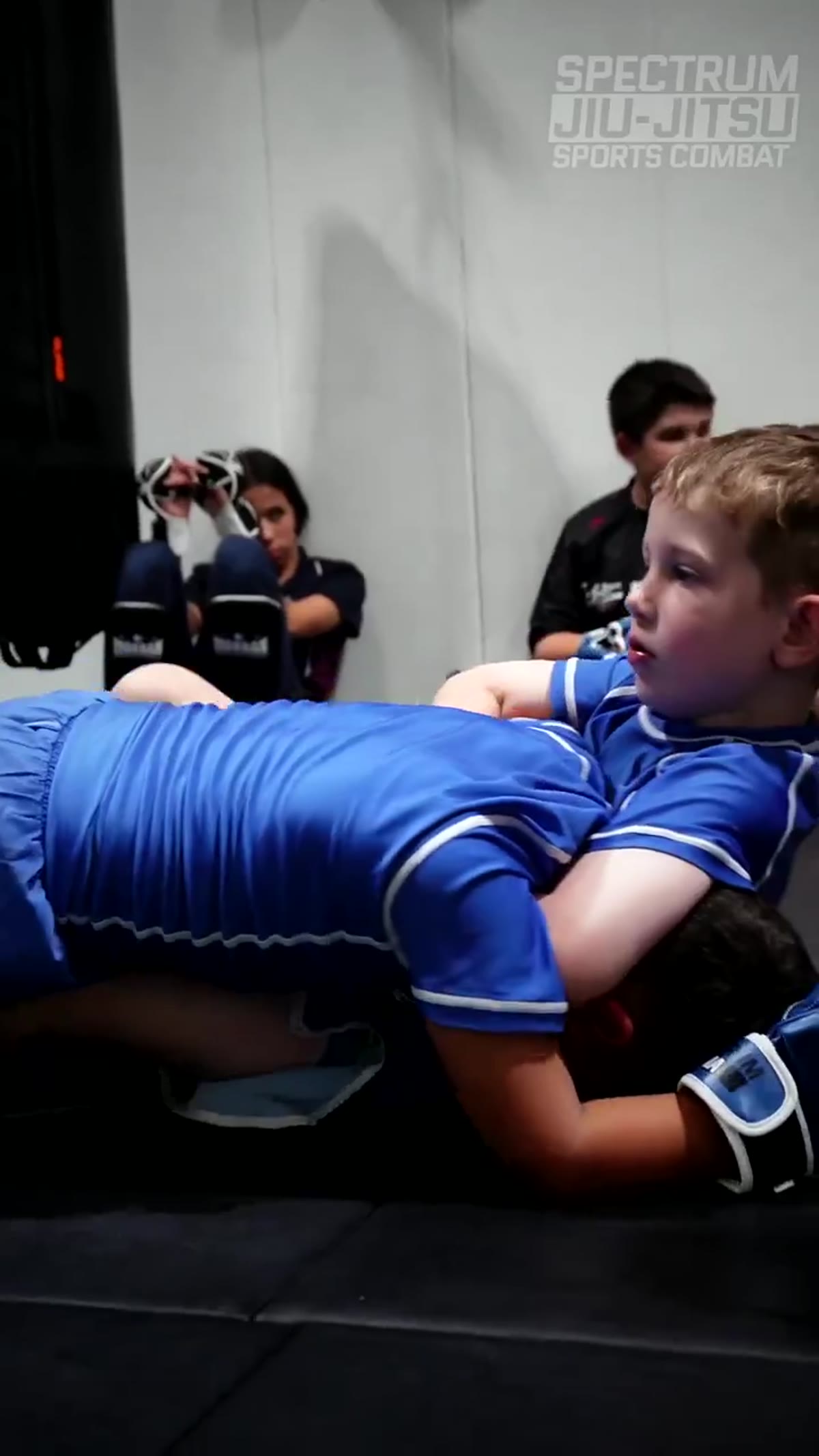 Kids grappling in class